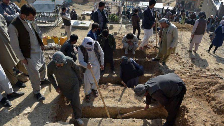 Afghans bury their dead after dozens of girls killed in school blasts