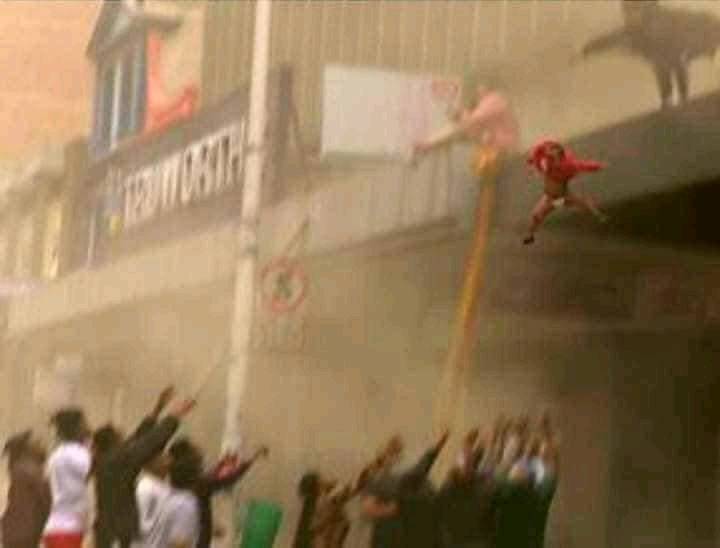 A mother from South Africa throws her baby to safety from a burning building
